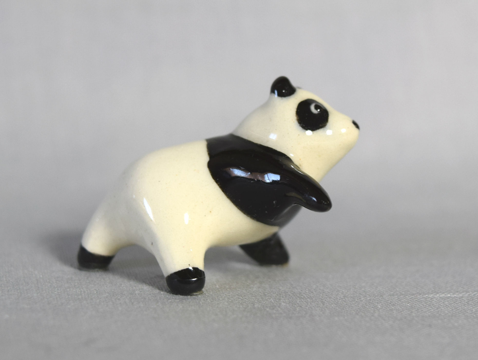 Panda on three legs, black chest main image